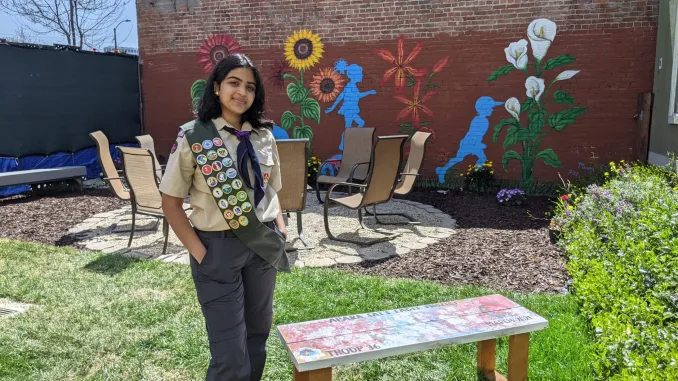 Apara in front of her Eagle Scout Project.