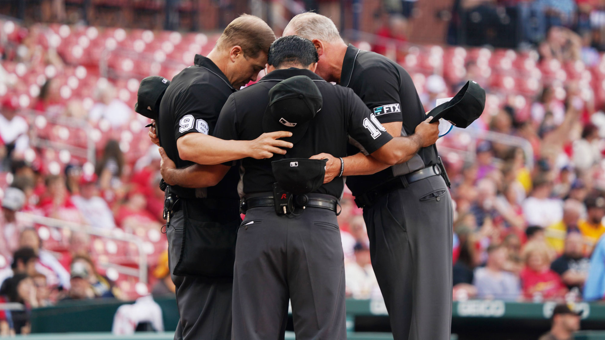 Chris and fellow umpires in prayer before starting a Major League game.