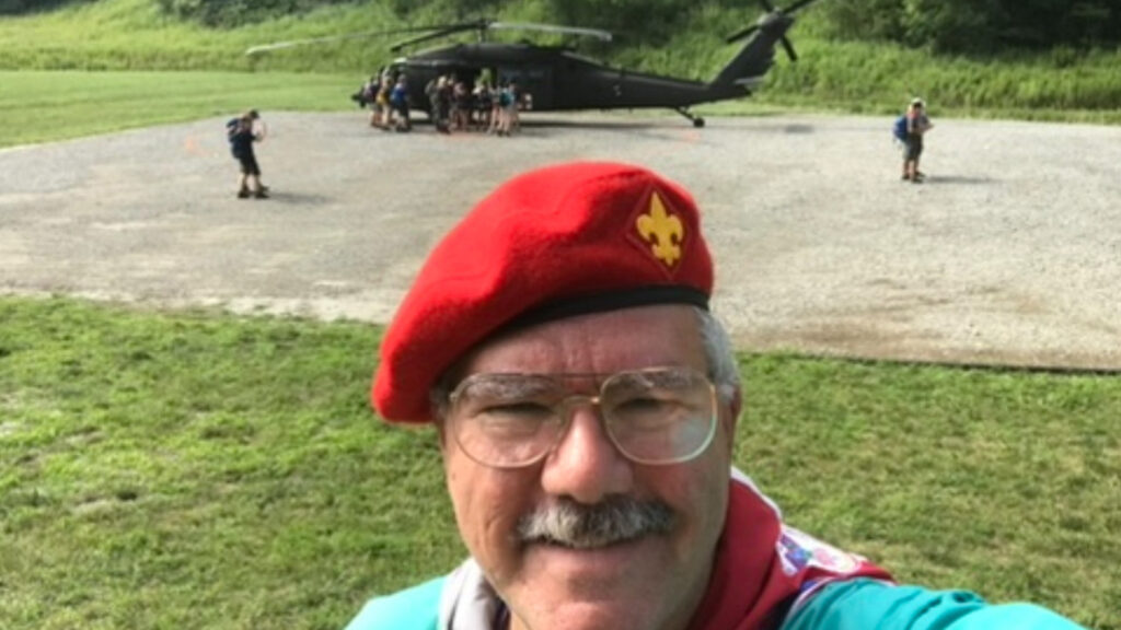 Mark Henderson in front of a helicopter.